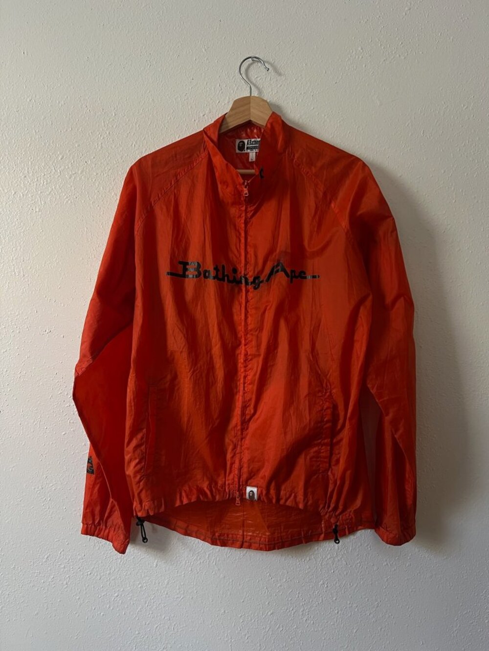 Vintage neon orange BAPE windbreaker jacket with large logo
